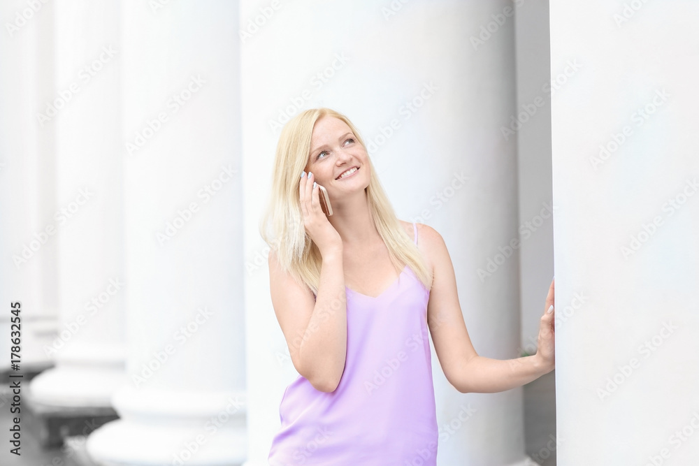 Beautiful young woman talking on mobile phone outdoors Beautiful young woman talking on mobile phone outdoors