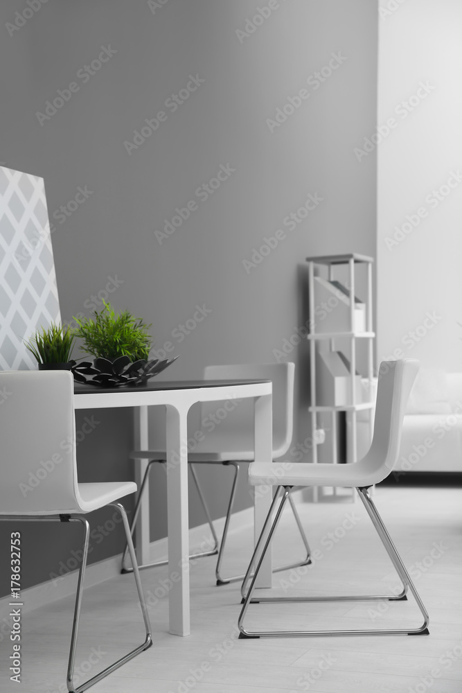 Modern room interior with white chairs and table Modern room interior with white chairs and table
