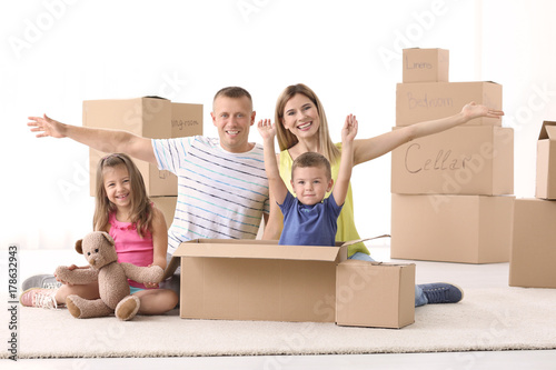 Happy family unpacking card...