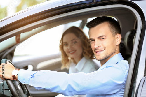 Beautiful young couple in car