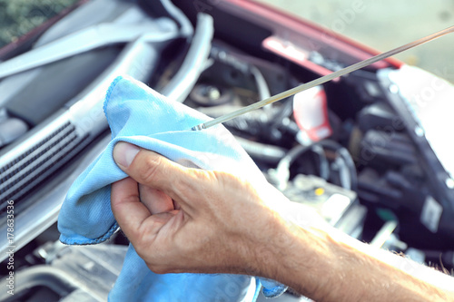 Car mechanic providing car service, closeup