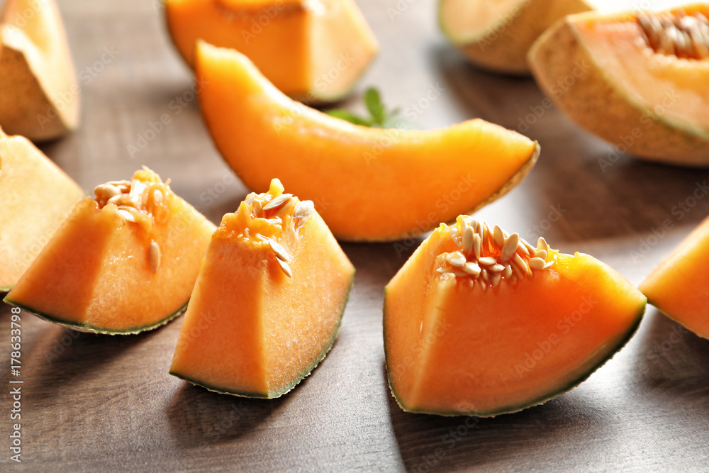 Fresh sliced melon on wooden background