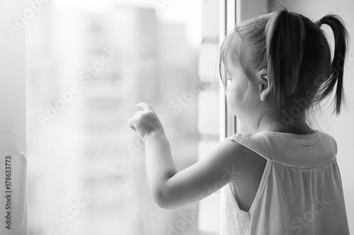 Free Download A little girl is sitting on the windowsill. A bouquet of flowers - GFXLoad