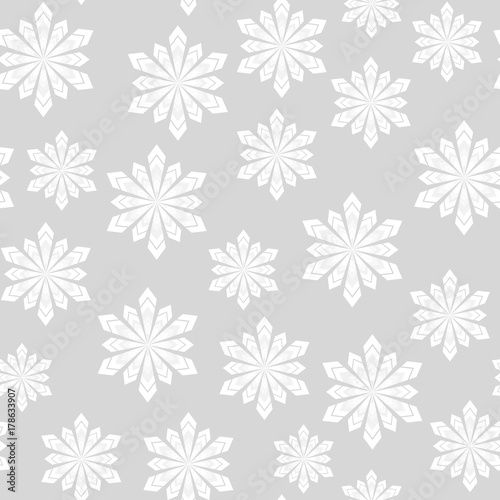 Winter seamless pattern. Snowflakes on a gray background. For your design.