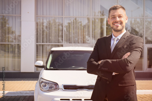 Salesman standing near new ...