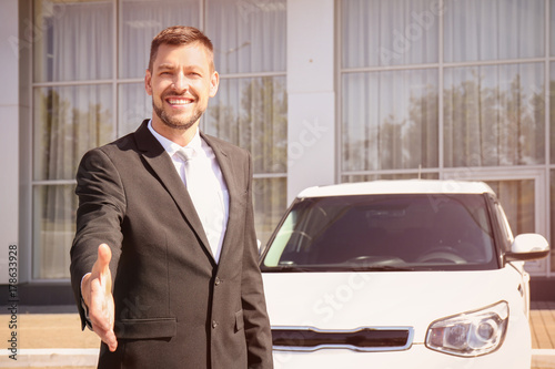 Salesman standing near new ...