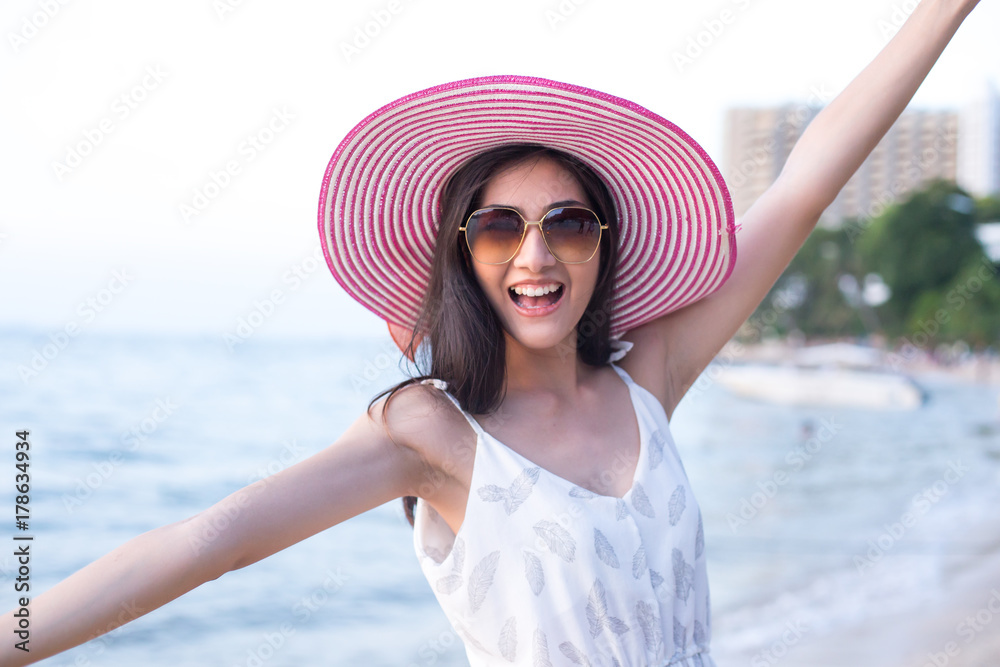 Portrait of happy young Asian woman standing at the Beach. Woman standing on the Beach with Happy Emotion  People Lifestyle Concept.