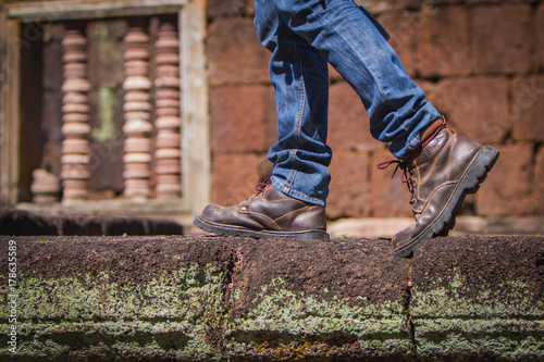 young man looking for freedom lifestyle ; man looking around the landmark at nature park