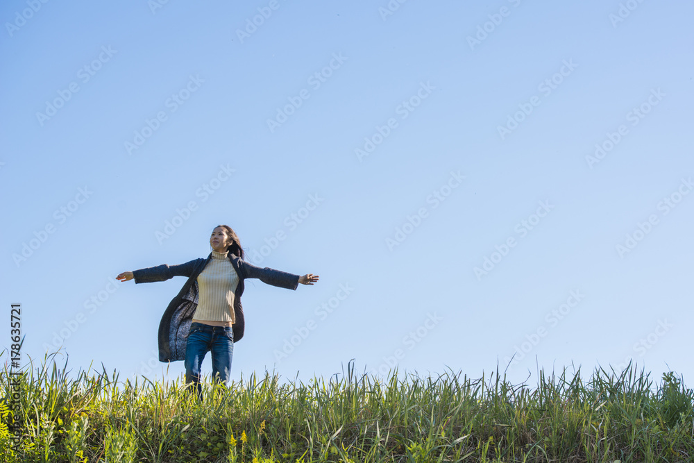A beautiful woman standing in the grassland A beautiful woman standing in the grassland