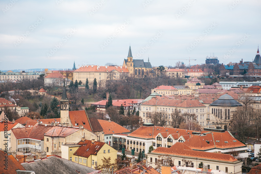 View from a high point. A beautiful view from above on the streets, roads and roofs of houses in Prague. Traditional ancient urban architecture.