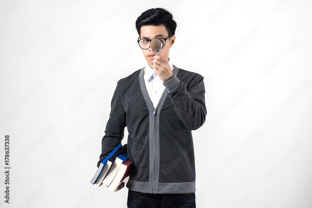 Young nerd man wearing glasses holding a book stack while standing isolated on white background. Young nerd man wearing glasses holding a book stack while standing isolated on white background.