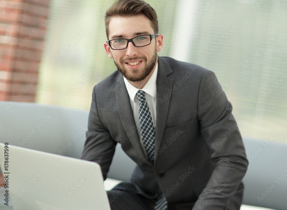 Portrait of a modern businessman sitting at his desk. Portrait of a modern businessman sitting at his desk.