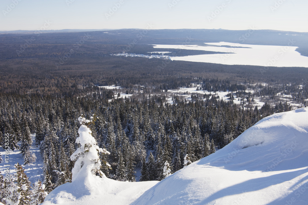 View of lake Zuratkul from Mountain range. Winter landscape.
