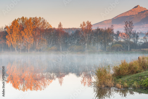 Sunrise light hits high mountains peaks in Tatra mountains