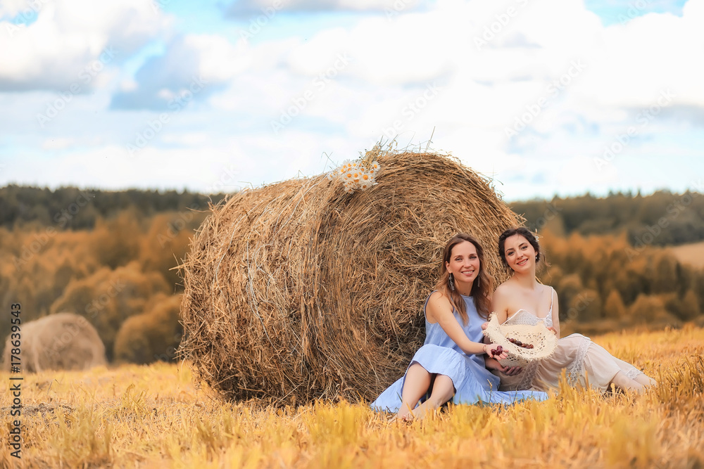 Two girls in dresses in autumn field Two girls in dresses in autumn field
