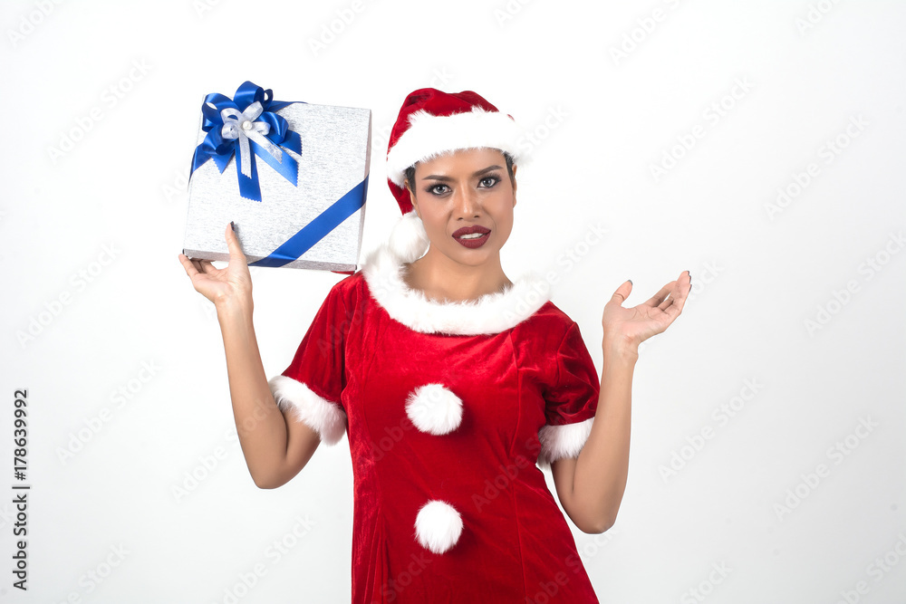 Obraz premium Young beautiful woman showing Christmas present isolated on white background.