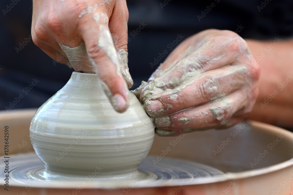 Potter making ceramic pot on the pottery wheel