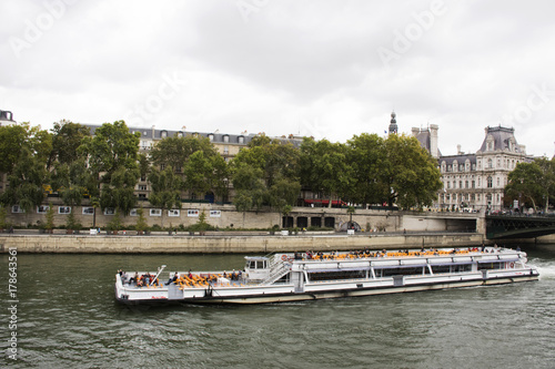 River Cruises sailing bring travelers passengers tour and looking old town Paris city at riverside of Seine river on September 6, 2017 in Paris, France