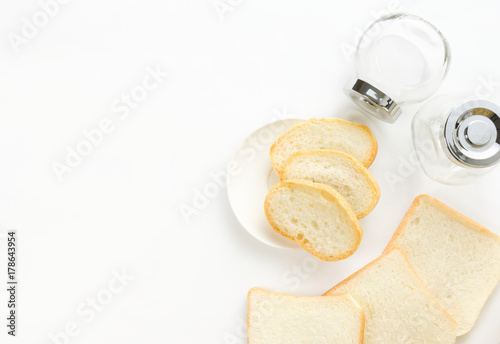 The bread on a white background and have the glass bottle located near.
