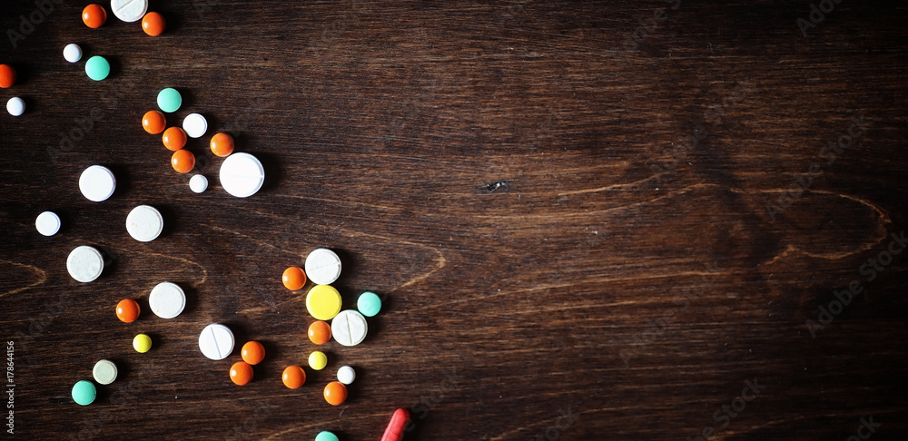 Drugs and pills on a wooden table. Various means to prevent cold