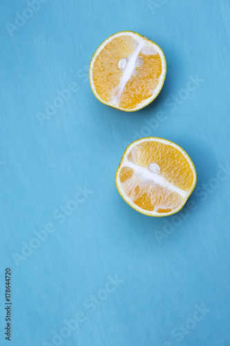 Fresh orange cut with space on blue wooden background
