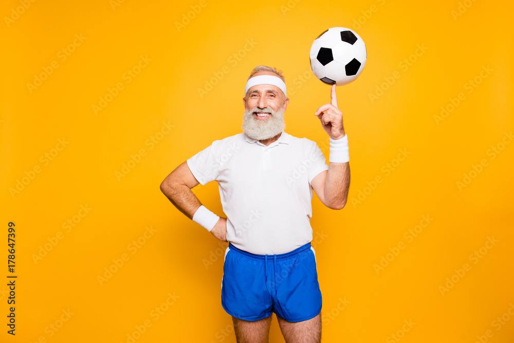 Fototapeta premium Bodycare, healthcare, weight loss, pride, strength, leadership, motivation, happiness, authority, gym concept. Cool funny modern competetive pensioner, leader, champion plays with ball