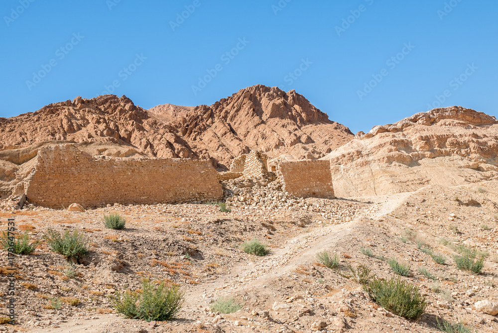 An ancient ruined stone wall in a mountain desert