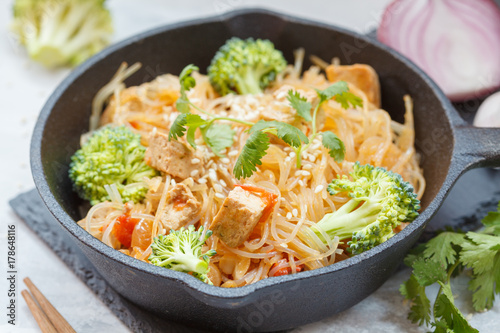 Fried vegan rice noodles with tofu and broccoli