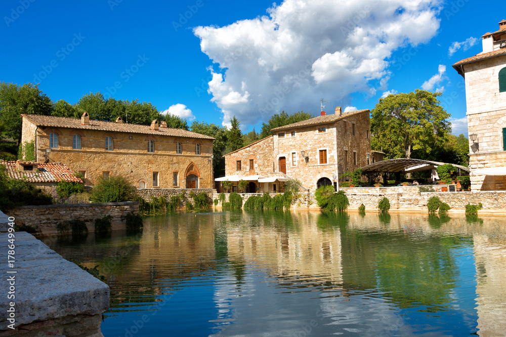 Old thermal baths in  medieval village Bagno Vignoni in sunny day, Tuscany, Italy