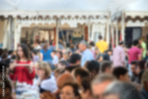 blurred crowd in a food festival, image of people not on focus (the picture is voluntarily defocused for background usage)
