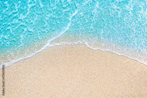 Sea Beach and Soft wave of blue ocean.  Summer day and sandy beach background. © nataliazakharova