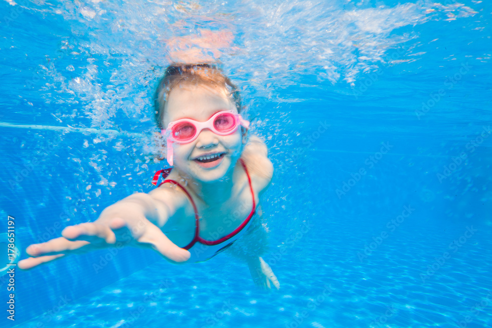 Little girl swimming in pool. Stock Photo | Adobe Stock