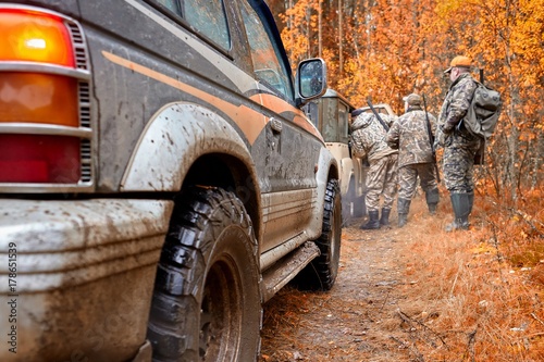Hunter in camouflage clothes with hunting rifle. Hunting in the forest