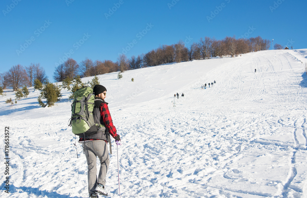 Male hiker on snow covered mountain