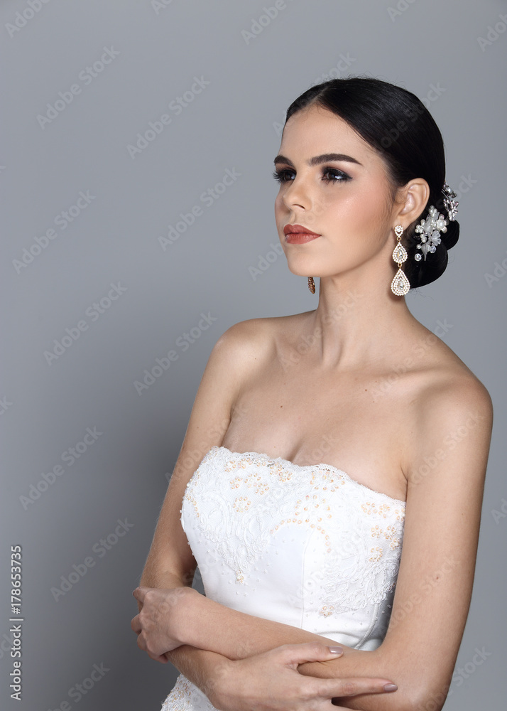 Lovely Caucasian Beautiful Woman bride in white wedding gown dress with lace, black hair Lovely Caucasian Beautiful Woman bride in white wedding gown dress with lace, black hair