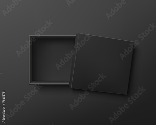Opened black empty gift box on dark background.