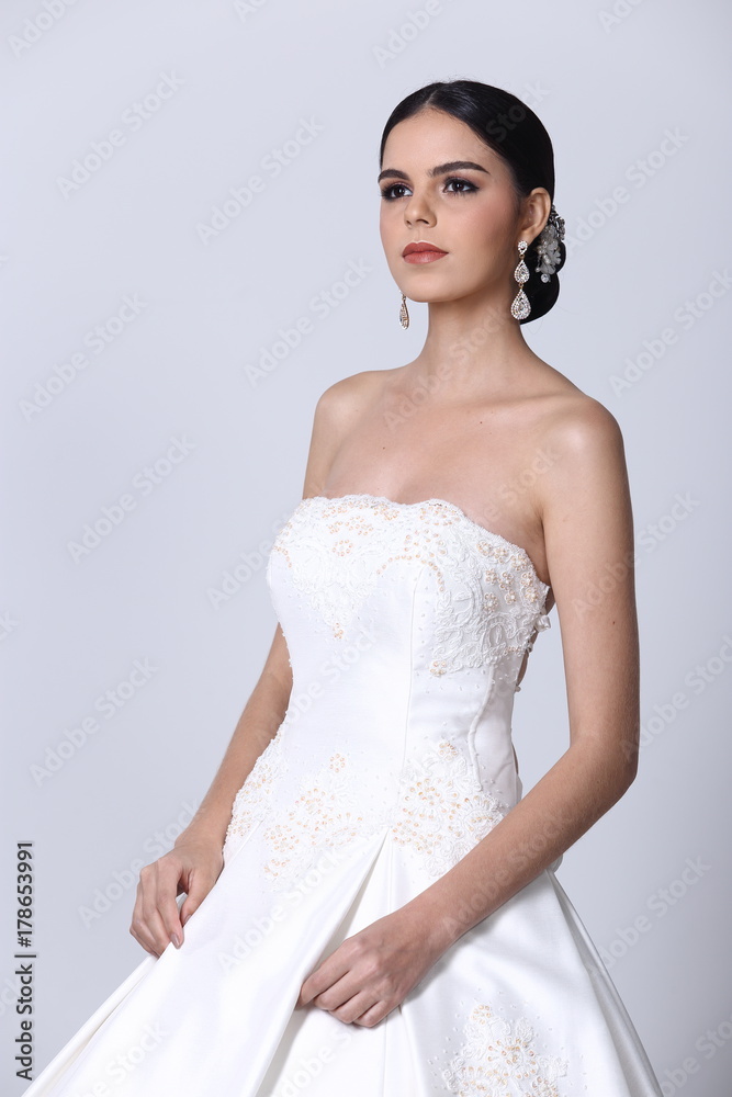 Lovely Caucasian Beautiful Woman bride in white wedding gown dress with lace, black hair Lovely Caucasian Beautiful Woman bride in white wedding gown dress with lace, black hair