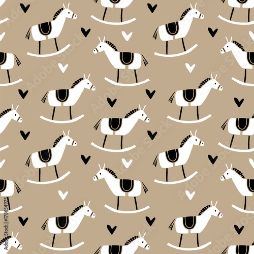 Cute Christmas seamless pattern with hand drawn wooden horse toys and hearts. Fabric or wrapping paper traditional design. Vector illustration background.