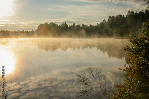 Sunrise over a misty Estonian Lake