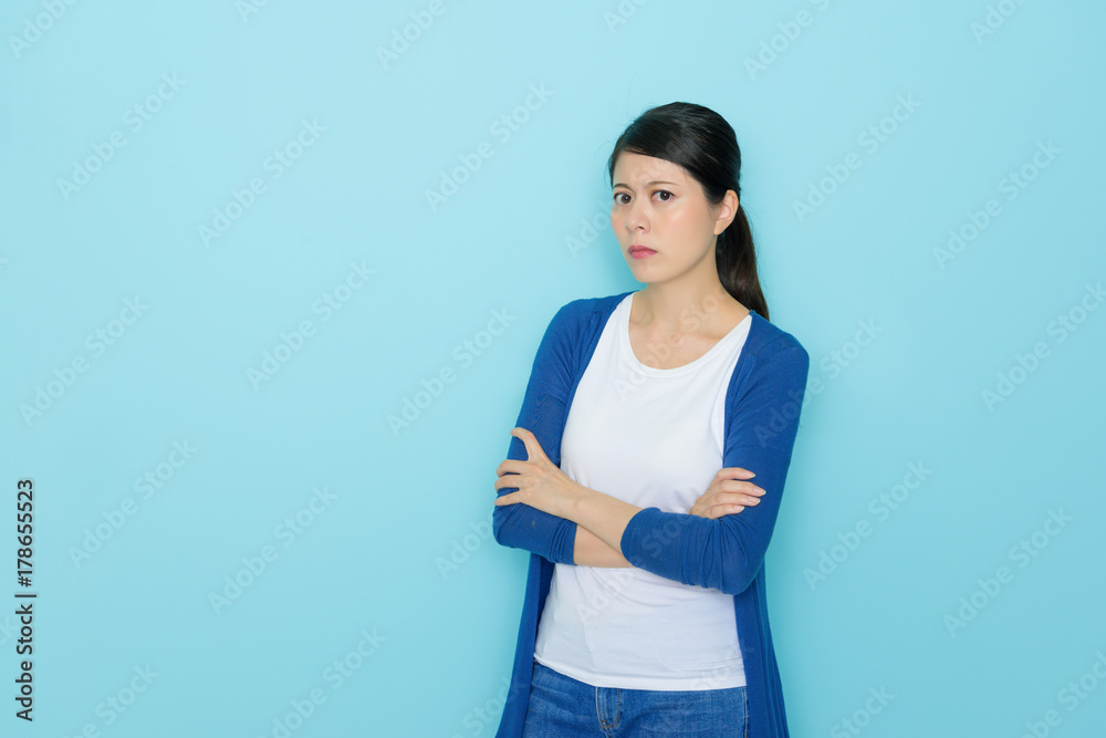 woman hands crossed standing in blue background woman hands crossed standing in blue background