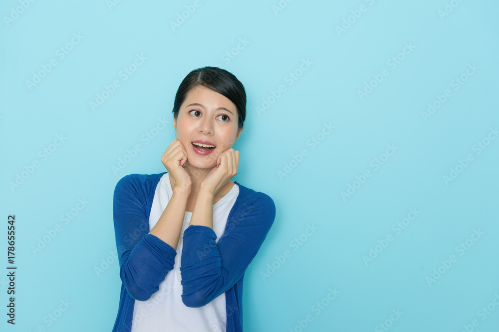 woman making cute posing in blue background