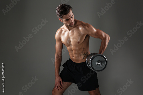Strong young concentrated sports man make sports exercises