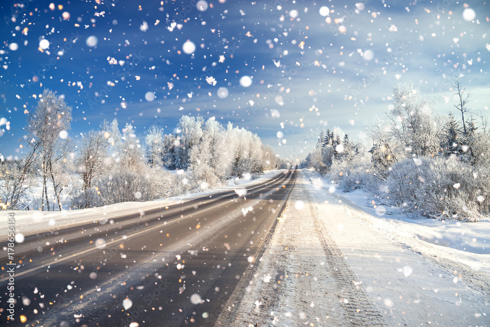 winter landscape with asphalt road,forest and blue sky. winter landscape with asphalt road,forest and blue sky.