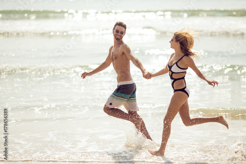 Attractive couple have fun on beach