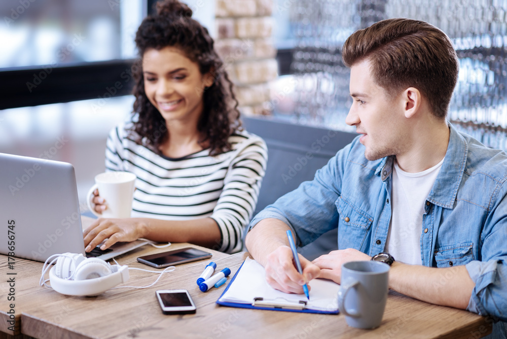 Alert woman and man sitting at the table Alert woman and man sitting at the table