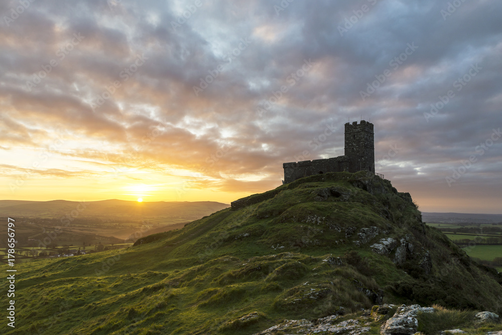 Brentor church at sunrise with beautiful sky and golden hues, Brentor, Devon, UK
