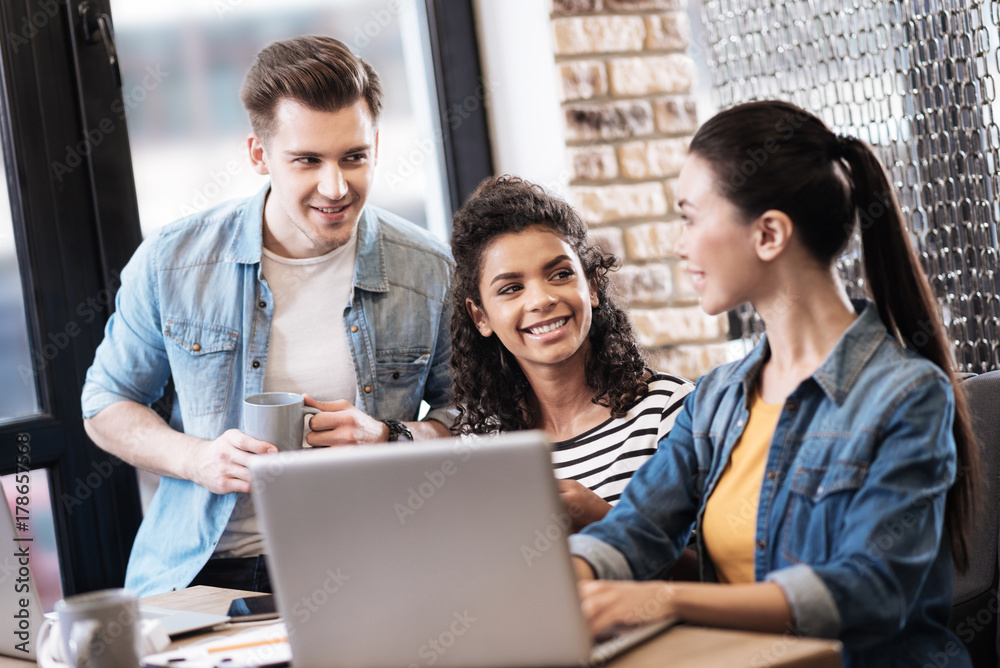 Aspiring man and two ladies and working on the laptop Aspiring man and two ladies and working on the laptop