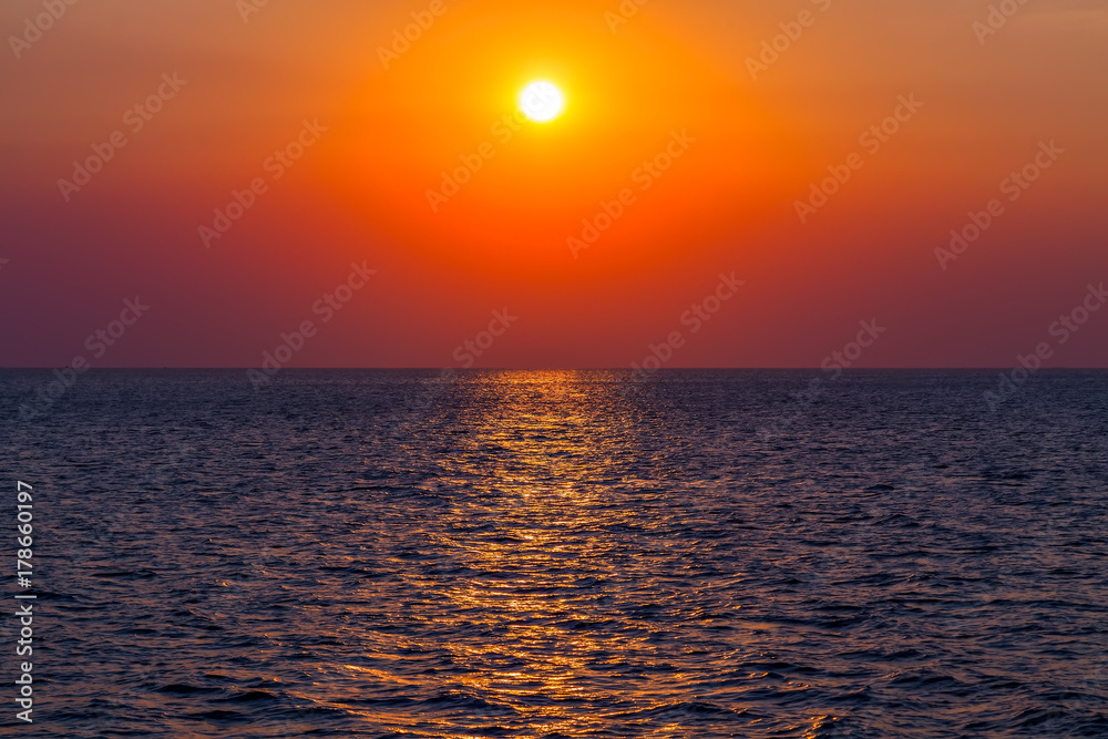 Orange light sky with clouds at sunset Seascape