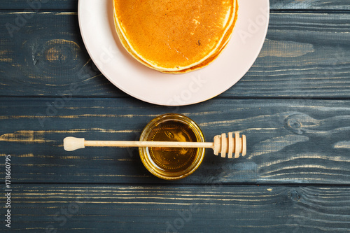 Tasty healthy breakfast - fresh pancakes with honey photo