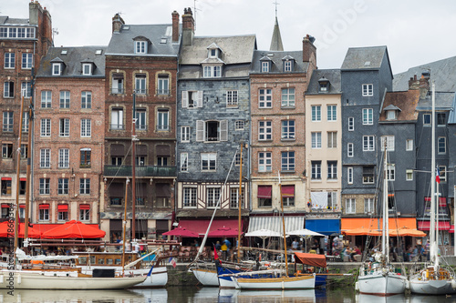 Yachts moored at quay port of Honfleur, France. Concepts of success, leisure, holiday, rich, tourism, luxury, lifestyle. Sunny Summer, blue sky